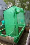 May 24, 2004 - Now, putting the plastic tent onto the frame was another story.  But in the end, it fit.  The big trick I've found with all these breezy days is keeping it erect.  Finally had to tie it to the raised bed to keep it from blowing across the yard.