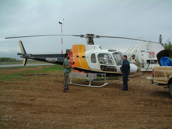 Biologist Dave Latham prepares to travel by helicopter to check on the many sites in his research area.  It covers 20,000 square kilometers in northeastern Alberta.