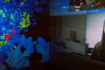 The Cave setup allows for simultaneous video conferencing between researchers at different locations while viewing the projected virtual molecule