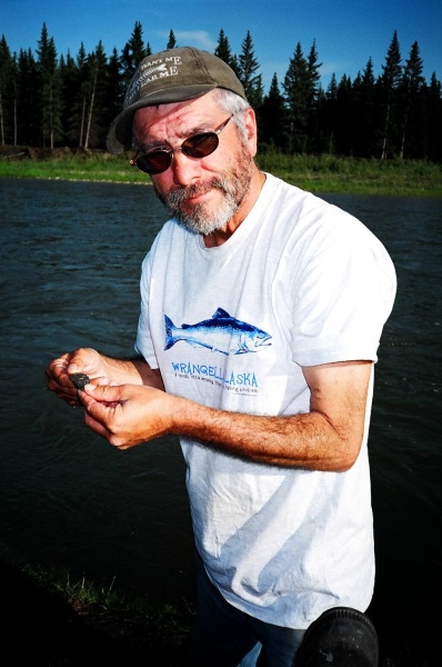 August 20, 2005 - My camping buddy Wayne Roberts holds up a tiny stone.  Nothing like a gravel bar along the banks of the Red Deer River to find stones and fossils.