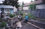 Cheryl and Wendy laying the first bricks for the fish pond in Cheryl's garden.